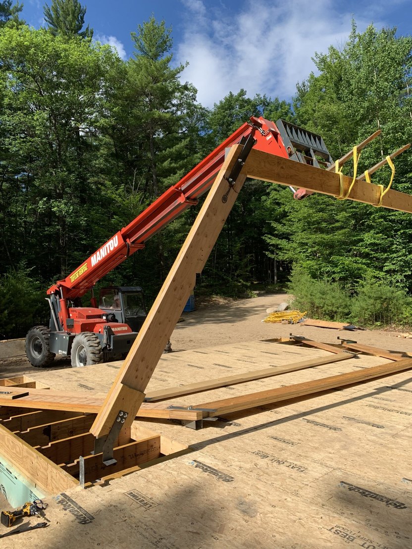 Crane lifting 30 foot beams for the center of ADK Aframe build.